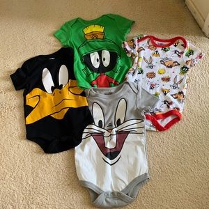 A set of baby looney tune onesies.